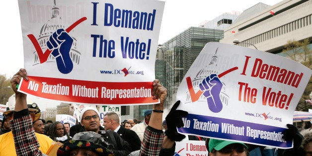 WASHINGTON - APRIL 16: Demonstrators hold posters during a march to ask for a voting representation for the nation's capital