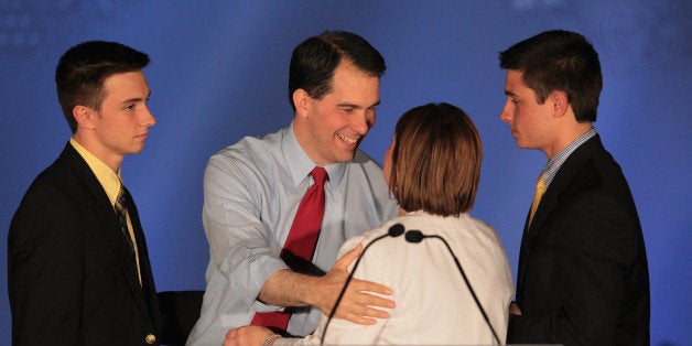 WAUKESHA, WI - JUNE 05: Wisconsin Governor Scott Walker greets his wife Tonette and sons Alex and Matt at an election-night rally June 5, 2012 in Waukesha, Wisconsin. Walker, only the third governor in history to face a recall election, defeated his Democrat contender Milwaukee Mayor Tom Barrett. Opponents of Walker forced the recall election after the governor pushed to change the collective bargaining process for public employees in the state. (Photo by Scott Olson/Getty Images)