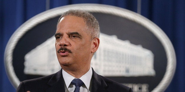 WASHINGTON, DC - MARCH 04: Attorney General Eric Holder delivers remarks about the Justice Department's findings related to two investigations in Ferguson, Missouri, at the Robert F. Kennedy Department of Justice Building March 4, 2015 in Washington, DC. Holder delivered the remarks for an audience of department employees who worked on the investigations after a white police officer shot and killed an unarmed black teenager, sparking weeks of demonstrations and violent clashes. (Photo by Chip Somodevilla/Getty Images)