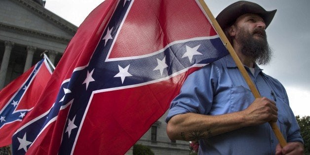 Pro-confederate flag demonstrator Jim Horky stands outside the South Carolina State House in Columbia, South Carolina, June 27, 2015. There has been a growing clamor for the flag -- branded 'a reminder of systemic oppression and racist subjugation' by President Barack Obama on Friday -- to be removed from the grounds of the state house in Columbia. Once flown by the rebel army of the slave-owning South, the confederate flag is seen by some as a symbol of regional heritage, but by many more as an ugly reminder of racism's cruel legacy. AFP PHOTO/JIM WATSON (Photo credit should read JIM WATSON/AFP/Getty Images)