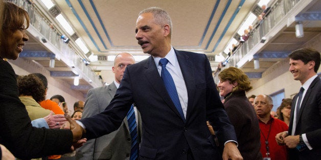 WASHINGTON, DC - APRIL 24: U.S. Attorney General Eric Holder shakes hands with Justice Department employees after delivering