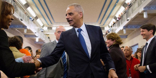 WASHINGTON, DC - APRIL 24: U.S. Attorney General Eric Holder shakes hands with Justice Department employees after delivering his parting remarks at the Robert F. Kennedy building April 24, 2015 in Washington, DC. The first African American attorney general in U.S. history, Holder is leaving his post as the country's highest ranking law enforcement official after six years on the job and will be succeeded by Loretta Lynch. (Photo by Chip Somodevilla/Getty Images)