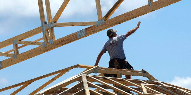 In this July 17, 2014 photo, construction workers build a commercial complex in Springfield, Ill. The Conference Board reports on its August index of leading economic indicators, which is designed to predict the economy's future health, on Friday, Sept. 19, 2014. (AP Photo/Seth Perlman)