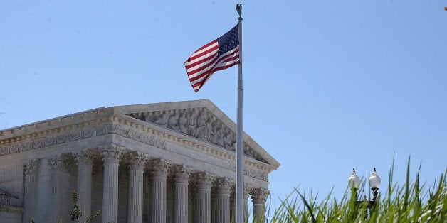WASHINGTON, DC - JUNE 29: An American flag flies over the U.S. Supreme Court June 29, 2015 in Washington, DC. Today the high