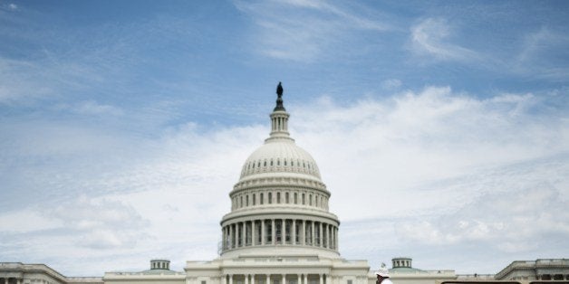 Tourists pass the US Capitol building on a tour bus July 19, 2014 in Washington, DC. AFP PHOTO/Brendan SMIALOWSKI (Pho