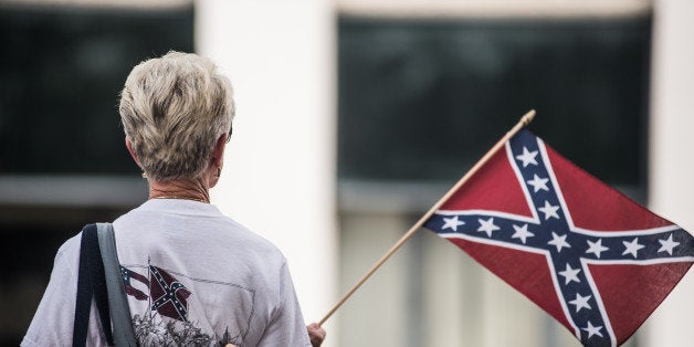 COLUMBIA, SC - JULY 8: A woman shows her support for the Confederate battle flag at the South Carolina state house July 8, 2015 in Columbia, South Carolina. South Carolina lawmakers will continue the debate today on whether to remove the flag from state house grounds. (Photo by Sean Rayford/Getty Images)