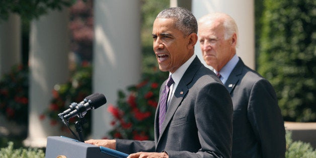 WASHINGTON, DC - JULY 01: U.S. Vice President Joe Biden (R) looks on as U.S. President Barack Obama speaks at a press conference in the Rose Garden at the White House July 1, 2015 in Washington, DC. Obama announced that Cuba and the United States would re-establish diplomatic ties, including an exchange of ambassadors and embassies. (Photo by Chip Somodevilla/Getty Images)