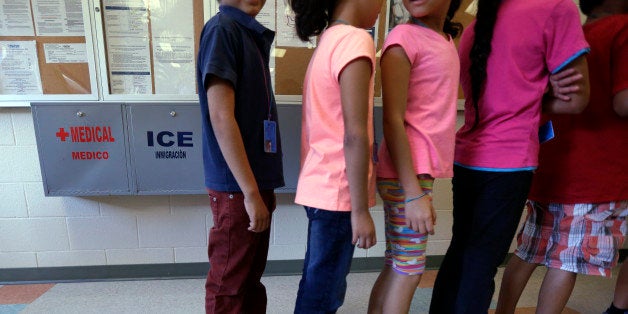 FILE - In this Sept. 10, 2014 file photo, detained immigrant children line up in the cafeteria at the Karnes County Resident