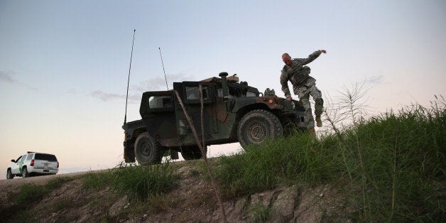 MCALLEN, TX - SEPTEMBER 08: Texas National Guard troops watch for illegal immigrant crossings near the Rio Grande River at t