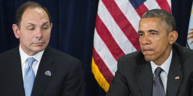 US President Barack Obama speaks alongside Secretary of Veterans Affairs Robert McDonald (L) following a briefing on US military veterans healthcare at the Veterans Affairs (VA) Medical Center in Phoenix, Arizona, March 13, 2015. The government announced a new advisory committee of private sector, non-profit and government leaders to improve the VA's ability to improve care for veterans from the Phoenix VA that was at the center of scandal last year regarding the health care of US military veterans. AFP PHOTO / SAUL LOEB (Photo credit should read SAUL LOEB/AFP/Getty Images)