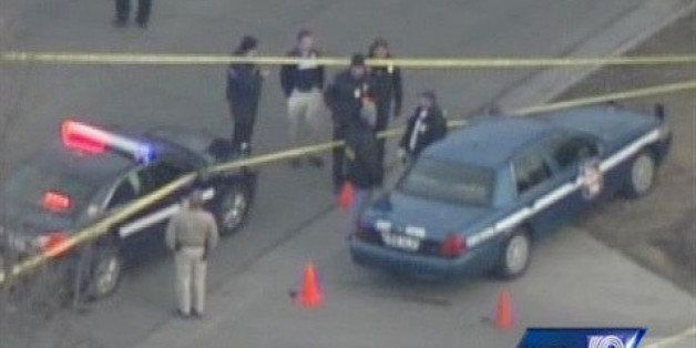 In this frame from video provided by WISN, officials surround the scene following a shooting Tuesday, March 24, 2015, in Fond Du Lac, Wis. Authorities say a Wisconsin state trooper was shot and killed in an exchange of gunfire with a person who matched the description of a bank robbery suspect. Police said the suspect also was killed. (AP Photo/WISN) MANDATORY CREDIT; TV OUT; LOCAL NEWS OUT