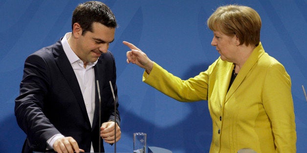 German Chancellor Angela Merkel, right, points as she and the Prime Minister of Greece Alexis Tsipras leave after a press conference as part of a meeting at the chancellery in Berlin, Germany, Monday, March 23, 2015. (AP Photo/Michael Sohn)