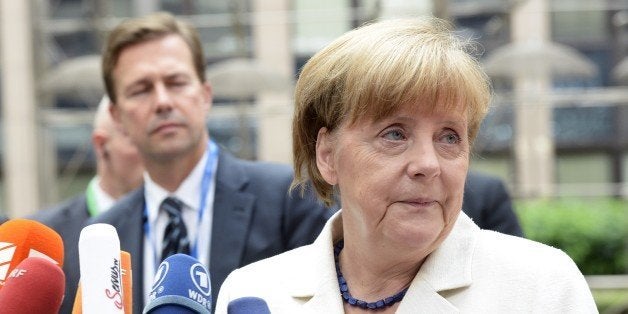 German Chancellor Angela Merkel talks to the media as he arrives for a meeting of the leaders of the 19 countries that use th
