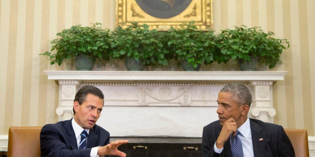 President Barack Obama hosts a bilateral meeting with Mexican President Enrique Pena Nieto, Tuesday, Jan. 6, 2015, in the Oval Office of the White House in Washington. The president is looking to his southern neighbor for help implementing the changing policies on immigration and Cuba. (AP Photo/Carolyn Kaster)