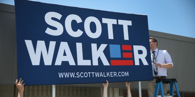 WAUKESHA, WI - JULY 13: Workers put up a sign outside of the Waukesha County Expo Center before Wisconsin Governor Scott Walker announces that he will seek the Republican nomination for president on July 13, 2015 in Waukesha, Wisconsin. Walker is the 15th candidate to formally announce intentions to seek the Republican nomination. (Photo by Scott Olson/Getty Images)