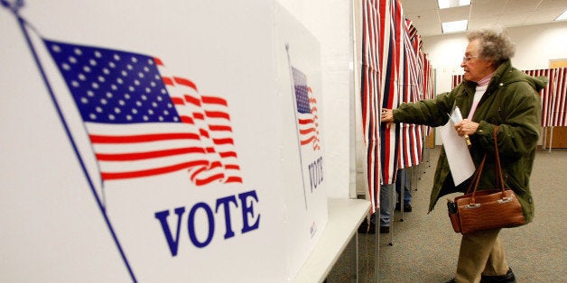 MANCHESTER, NH - JANUARY 08: Harriet Boylan heads into a voting booth to cast her vote in the New Hampshire presidential primary at the Ward 3 Carol M. Rines Center January 8, 2008 in Manchester, New Hampshire. New Hampshire residents vote today in the nation's first presidential primary. (Photo by Win McNamee/Getty Images)