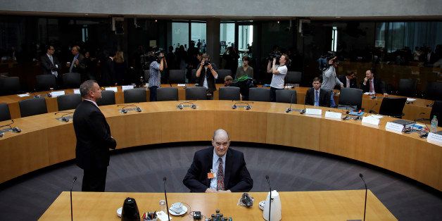 A police officer stands next to former US National Security Agency, NSA, employee William Binney, center, as Binney waits for his questioning by the German parliamentary NSA investigation committee in Berlin, Germany, Thursday, July 3, 2014. The committee investigates the NSA surveillance activities, that also included the tapping of German Chancellor Angela Merkel. (AP Photo/Michael Sohn)