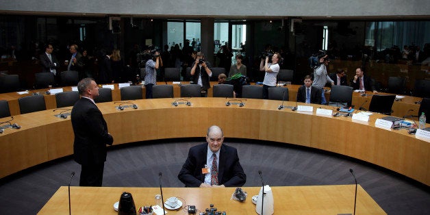 A police officer stands next to former US National Security Agency, NSA, employee William Binney, center, as Binney waits fo