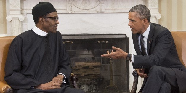 US President Barack Obama speaks with Nigerian President Muhammadu Buhari during a meeting in the Oval Office of the White Ho