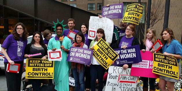 WASHINGTON, DC - MARCH 22: Demonstrators hold signs while participating in a protest outside of the Hyatt Regency where Republican presidential candidate, former Massachusetts Gov. Mitt Romney was scheduled to attend a fundraiser on March 22, 2012 in Washington, DC. Supporters of Planned Parenthood, and the National Association for the Repeal of Abortion Laws (NARAL), participated in the protest against Romney's position on women's health care. (Photo by Mark Wilson/Getty Images)