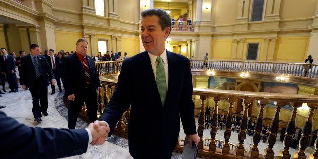 Kansas Gov. Sam Brownback greets supporters as he leaves the house chambers after his Inaugural Ceremony, Monday, Jan. 12, 2015, at the Kansas Statehouse in Topeka, Kan. (AP Photo/Charlie Riedel)