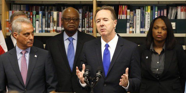 Forrest Claypool, second from right, and new CEO of Chicago Public Schools, addresses reporters after Mayor Rahm Emanuel, left, named Claypool to the post during a news conference Thursday, July 16, 2015, in Chicago. Also listening to Claypool's remarks are Frank Clark, second from left, the new President of the Chicago Board of Education, and Janice Jackson, the new Chief Education Officer. (AP Photo/Charles Rex Arbogast)