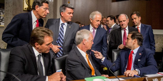 Clockwise from top left, Sen. John Barrasso, R-Wyo., Sen. Cory Gardner, R-Colo., Chairman Sen. Bob Corker, R-Tenn., Sen. James Risch, R-Idaho, Sen. Jeff Flake, R-Ariz., Sen. Ron Johnson, R-Wisc., and Republican presidential candidate, Sen. Marco Rubio, R-Fla., speak together before Secretary of State John Kerry, Secretary of Energy Ernest Moniz, and Secretary of Treasury Jack Lew, arrive to testify at a Senate Foreign Relations Committee hearing on Capitol Hill, in Washington, Thursday, July 23, 2015, to review the Iran nuclear agreement. (AP Photo/Andrew Harnik)