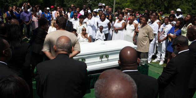 WILLOW SPRINGS, IL - JULY 25: Mourners gather at the grave site of Sandra Bland at Mt. Glenwood Memorial Gardens West cemetery, on July 25, 2015 in Willow Springs, Illinois. Bland's death roused suspicion nationwide after the 28-year-old was found hanging from a plastic bag three days after she was pulled over by a Texas State Trooper for a traffic violation. (Photo by Jonathan Gibby/Getty Images)