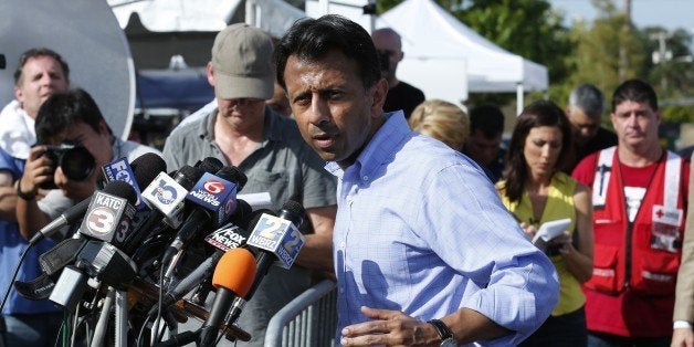 Louisiana Governor Bobby Jindal talks to the media after observing the crime scene inside The Grand Theatre following the pre
