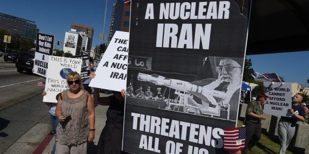 Members of the 'Stand With Us' group hold a rally calling for the rejection of the proposed Iran nuclear deal outside the Federal Building in Los Angeles on July 26, 2015. White House contender Mike Huckabee is warning that President Barack Obama is marching the Israelis to the 'door of the oven' by signing off on the nuclear deal struck between Iran and six world powers. Iran clinched the agreement with Britain, China, France, Germany, Russia and the United States two weeks ago. AFP PHOTO/MARK RALSTON (Photo credit should read MARK RALSTON/AFP/Getty Images)