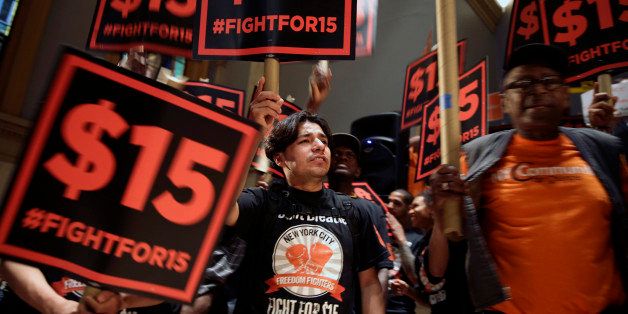 FILE - In this June 15, 2015, file photo, demonstrators rally for a $15 minimum wage before a meeting of the state Wage Board in New York. The New York state Wage Board is expected to recommend a higher minimum wage for the industry during a meeting Wednesday, July 22, 2015, in New York City. Board members say they support an increase, though they havenât offered a specific amount. (AP Photo/Seth Wenig, File)