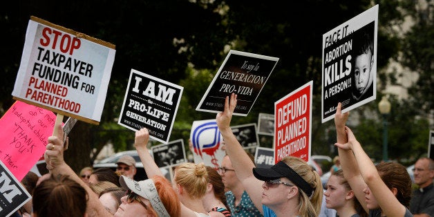 WASHINGTON, DC - JULY 28: Anti-abortion activists hold a rally opposing federal funding for Planned Parenthood in front of the U.S. Capitol on July 28, 2015 in Washington, DC. Sen. Rand Paul (R-KY) announced a Senate deal to vote on legislation to defund Planned Parenthood before the Senate goes into recess in August. (Photo by Olivier Douliery/Getty Images)