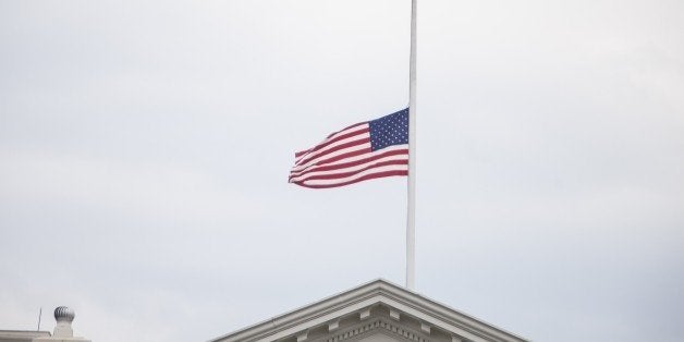 WASHINGTON, USA - JULY 21: The American Flag flies above the White House after President Barack Obama ordered it lowered to half staff in honor of the four Marines and one Sailor killed in Chattanooga, TN in Washington, USA on JULY 21, 2015. (Photo by Samuel Corum/Anadolu Agency/Getty Images)