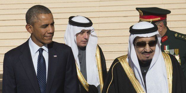 US President Barack Obama stands alongside Saudi new King Salman (R) after arriving on Air Force One at King Khalid International Airport in the capital Riyadh on January 27, 2015. Obama landed in Saudi Arabia to shore up ties with new King Salman and offer condolences after the death of his predecessor Abdullah. AFP PHOTO / SAUL LOEB (Photo credit should read SAUL LOEB/AFP/Getty Images)