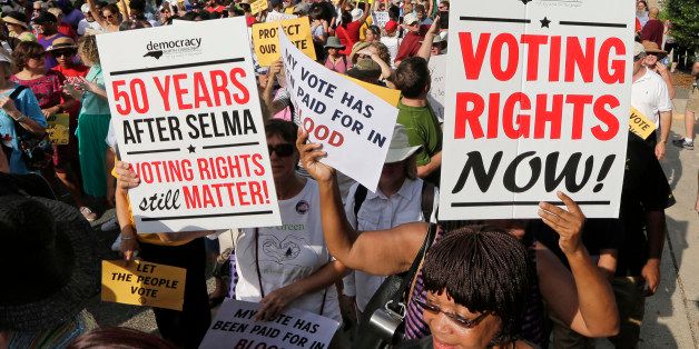 Demonstrators march through the streets of Winston-Salem, N.C., Monday, July 13, 2015, after the beginning of a federal voting rights trial challenging a 2013 state law. Election law experts say the case could determine how far Southern states can change voting rules after the nation's highest court struck down a portion of the federal Voting Rights Act just weeks before the North Carolina law was passed. (AP Photo/Chuck Burton)