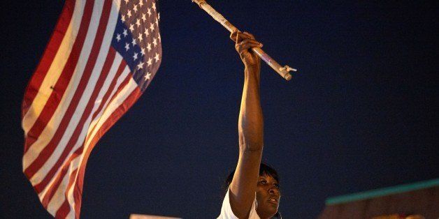 Demonstrators protest during a march on August 8, 2015 at the Ferguson Police Department in Ferguson, Missouri. Several hundred people marched Saturday in Ferguson to mark the first anniversary of the police shooting of unarmed black teen Michael Brown, which shone a spotlight on race relations in America. The crowd worked its way along one of the avenues hit by fierce rioting last November when a court decided not to indict the white officer who shot 18-year-old Brown. AFP PHOTO/MICHAEL B. THOMAS (Photo credit should read Michael B. Thomas/AFP/Getty Images)