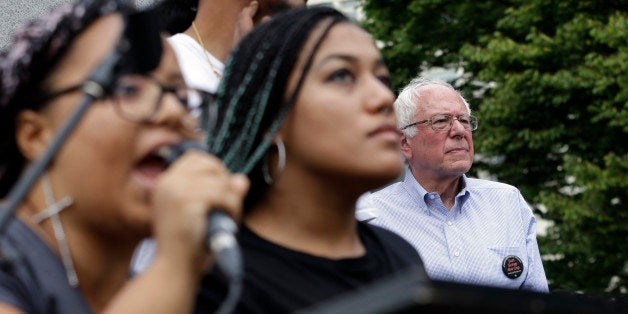 Marissa Johnson, left, speaks as Mara Jacqueline Willaford stands with her and Democratic presidential candidate Sen. Bernie