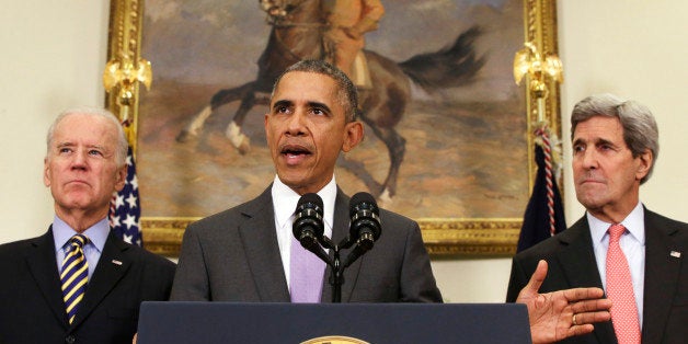 President Barack Obama, flanked by Vice President Joe Biden and Secretary of State John Kerry, gestures as he speaks about the Islamic State group, Wednesday, Feb. 11, 2015, in the Roosevelt Room of the White House in Washington. Obama asked the U.S. Congress on Wednesday to authorize military force to "degrade and defeat" Islamic State forces in the Middle East without sustained, large-scale U.S. ground combat operations, setting lawmakers on a path toward their first war powers vote in 13 years. (AP Photo/Jacquelyn Martin)