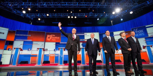 Republican presidential candidates from left, former Florida Gov. Jeb Bush, former Arkansas Gov. Mike Huckabee, Sen. Ted Cruz, R-Texas, Sen. Rand Paul, R-Ky., and Ohio Gov. John Kasich take the stage for the first Republican presidential debate at the Quicken Loans Arena, Thursday, Aug. 6, 2015, in Cleveland. (AP Photo/Andrew Harnik)