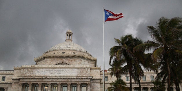 SAN JUAN, PUERTO RICO - JULY 01: The Puerto Rican flag flies near the Capitol building as the island's residents deal with t