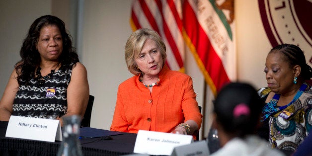 Democratic presidential candidate Hillary Rodham Clinton, center, speaks as she is joined by home care worker Regina Sutton, left, and home care consumer Karen Johnson, right, during a roundtable discussion on home care, Thursday, Aug. 6, 2015, in Los Angeles. (AP Photo/Jae C. Hong)