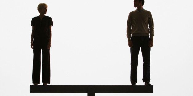 Two people standing on top of a plank