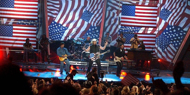 Toby Keith, center, performs "Courtesy of the Red, White & Blue" at the 37th Annual Academy of Country Music Awards Wednesday, May 22, 2002, in Los Angeles. (AP Photo/Kevork Djansezian)