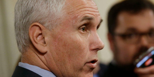 Indiana Gov. Mike Pence speaks with the media after emerging from Speaker of the House Brian Bosma's, R-Indianapolis, office on the final day of the 2015 legislative session at the Statehouse in Indianapolis, Wednesday, April 29, 2015. Indiana lawmakers are expected to work into the night Wednesday to wrap up the 2015 legislative session, signing off on a new two-year state budget and putting contentious issues such as control over the State Board of Education and a religious objections law behind them. (AP Photo/AJ Mast)