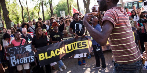 TORONTO, ON- JULY 27 - Desmond Cole addresses the crowd gathered for the Black Lives Matter protest, which started on Gilbert