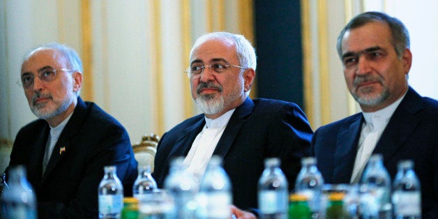 Iranian Foreign Minister Mohammad Javad Zarif, centre, Head of the Iranian Atomic Energy Organization Ali Akbar Salehi, left, and Hossein Fereydoon, brother and close aide to President Hassan Rouhani, meet with U.S. Secretary of State John Kerry in Vienna, Austria, Friday July 3, 2015. Iran has committed to implementing the IAEA's "additional protocol" for inspections and monitoring as part of an accord, but the rules don't guarantee international monitors can enter any facility including sensitive military sites, so making it difficult to investigate allegations of secret work on nuclear weapons. (Carlos Barria/Pool via AP)