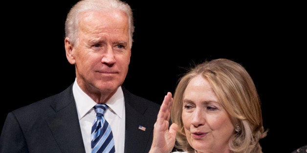 Vice President Joe Biden and former Secretary of State Hillary Rodham Clinton appear onstage at the Vital Voices Global Partnership 2013 Global Leadership Awards gala at the Kennedy Center for the Performing Arts in Washington, Tuesday, April 2, 2013. (AP Photo/Cliff Owen)