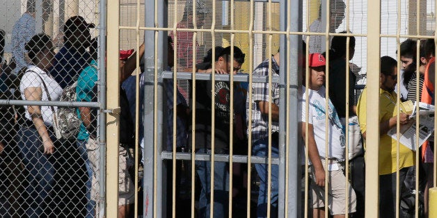Pedestrians wait in line to enter the U.S. from Mexico in Laredo, Texas, across the Rio Grande from Nuevo Laredo, Tamaulipas,