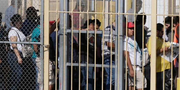 Pedestrians wait in line to enter the U.S. from Mexico in Laredo, Texas, across the Rio Grande from Nuevo Laredo, Tamaulipas, Thursday, July 23, 2015. (AP Photo/LM Otero)