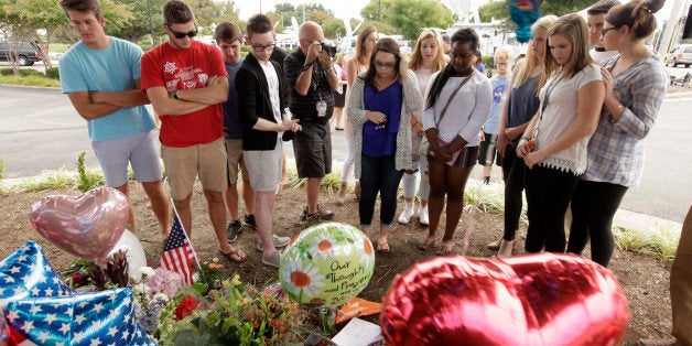 ROANOKE, VA - AUGUST 27: Mass communication students from the Burton Center come to pay their respects at a memorial at WDBJ Channel 7's station August 27, 2015 in Roanoke, Virginia. WDBJ reporter Alison Parker and cameraman Adam Ward. Parker, were reportedely killed by Vester Lee Flanigan, also known as Bryce Williams, during a live broadcast on August 26th in Moneta, Virginia. Williams later died of a self-inflicted gunshot wound. (Photo by Jay Paul/Getty Images)